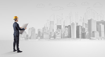 Young supervisor architect standing and replanning a big city panorama
