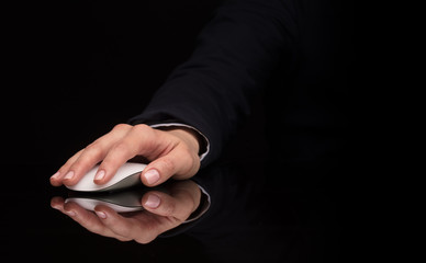 Hand using wireless mouse in a dark environment
