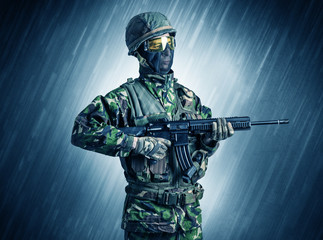 Armed soldier standing in rainy weather
