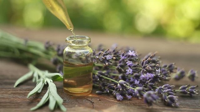 lavender essential oil in  beautiful bottle on table