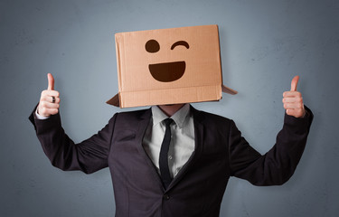 Funny man wearing cardboard box on his head with smiley face
