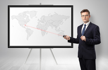 Handsome businessman with laser pointer  presenting potential business area on map
