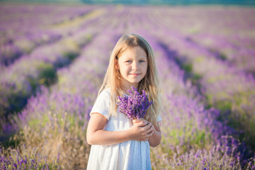 Portrait of a beautiful girl in a white dress with a bouquet of lavender