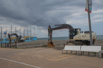 Excavator on the reclamation land. excavator at sea beach shore to renovate and relocation prepare for development
