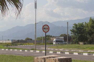 Highway, road traffic with cars and trucks. Road sign informing