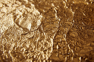 sheet golden foil with blurred bright glares