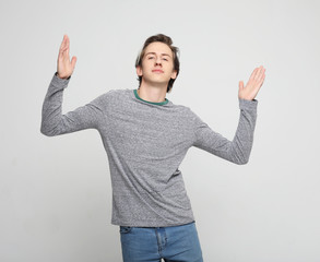 Fototapeta premium Happy young handsome man gesturing and keeping mouth