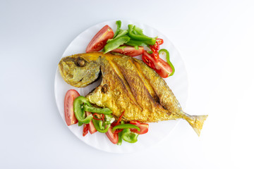 Fried fish on white background with selective focus and crop fragment