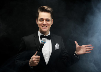Young handsome man with microphone