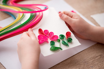 Quilling technique. Making decorations or greeting card. Paper strips, flower, scissors. Handmade...