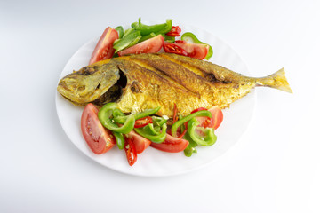 Fried fish on white background with selective focus and crop fragment