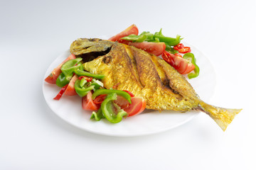 Fried fish on white background with selective focus and crop fragment