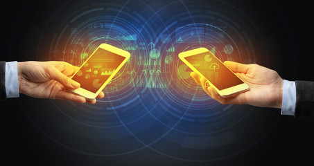 Close up of two smartphones syncing business data