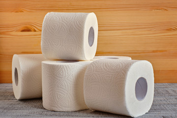 Toilet paper rolls on wood background