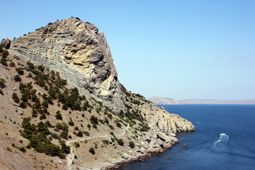 Fototapeta na wymiar beautiful panoramic view of a large steep stone cliff on the deep blue sea in Crimea