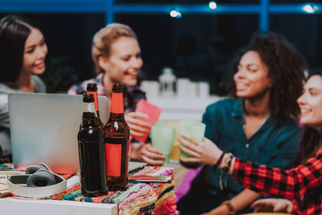 Female friends clanging glasses together at hen-party