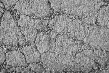 Gray background of textured concrete with cracks