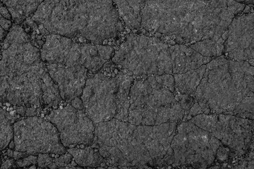 Dark grey textured concrete wall as an abstract background with cracks for poster, calendar, post, screensaver, wallpaper, postcard, card, banner, cover, website. A place for your design or text