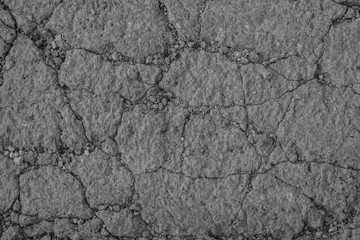 Gray textured concrete wall as an abstract background with cracks for poster, calendar, post, screensaver, wallpaper, postcard, card, banner, cover, website. A place for your design or text