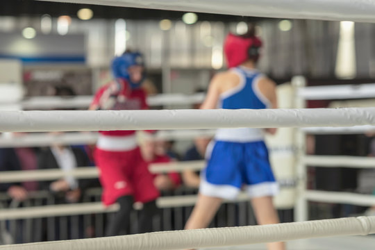 Blurred image of young athletes boxers in a ring boxing game