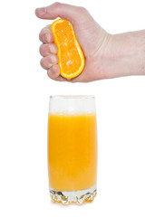 man squeezes orange in a glass