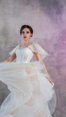 Beautiful and stylish bride in wedding dress with a lush flying skirt in
