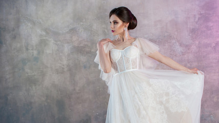 Beautiful and stylish bride in wedding dress with a lush flying skirt in