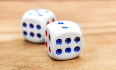 Dice on wooden background. Close up.