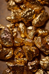 top view of golden stones on brown background