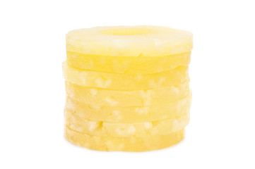 Stack of canned pineapple rings on white.