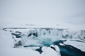 godafoss waterfall in northern iceland frozen in the winter cover by snow 