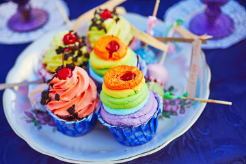 Tea party with cupcakes and different colorful cups