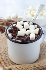 Hot chocolate with marshmallows in a white metal vintage mug