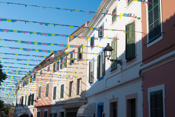 A joyful street of El Mercadal city of the spanish island