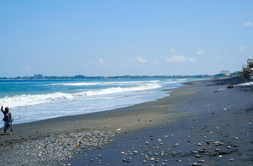 Oceanic coast with black volcanic sand on the island of Bali 