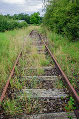 Abandoned railway covered with grasses