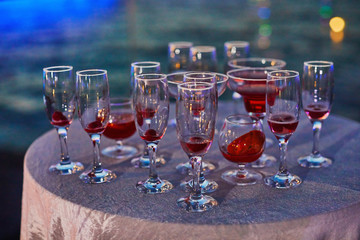 Many different cocktail glasses at sunset sea party