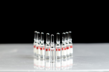 Of the medication vial. Glass ampoules with medicine. Fluid medication standing in a row