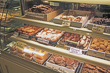 An assortment of baked goods displayed in a glass covered display case in a cafe shop in Mykonos...