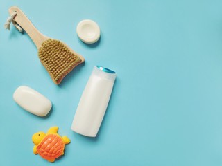Flat lay photo bath products. Natural shampoo, soap, massage brush on a light blue background. Toiletry set 