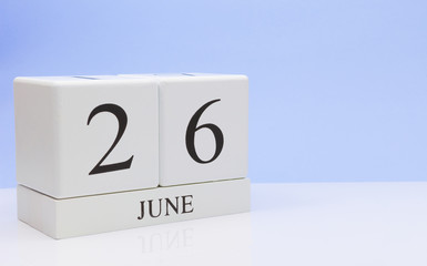 June 26st. Day 26 of month, daily calendar on white table with reflection, with light blue background. Summer time, empty space for text