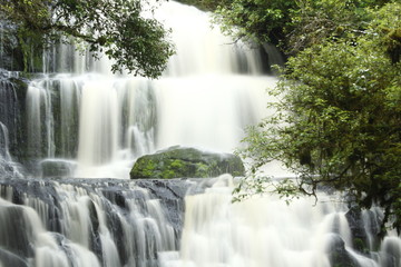 Meditative zen and yoga view of waterfall with resilient stone