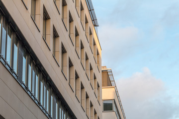 facade of a modern office building with blue sky