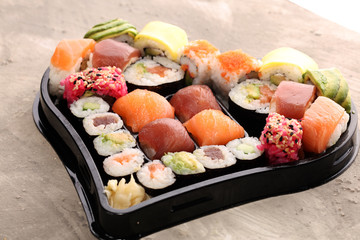 close up of sashimi sushi set with chopsticks and soy - sushi roll with salmon and sushi roll with smoked eel
