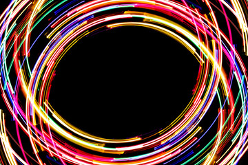 Abstract rotating neon lights texture with black empty copy space inside.