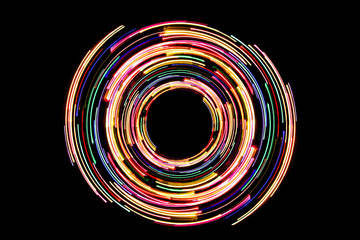 Abstract neon circle lines with empty copy space inside isolated on black background. Colorful led lights long exposure rotation photo. © Paweł Michałowski