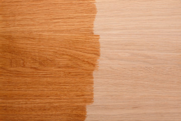 The process of coating a new wooden surface with varnish or oil.