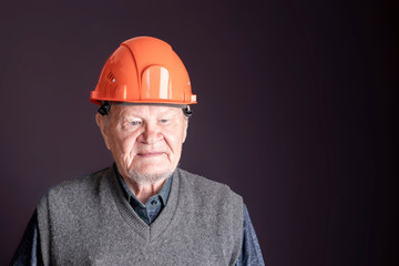 old senior worker in hardhat helmet, pension, dismissal