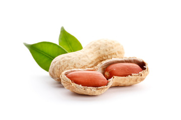 Raw peanuts on white background with green leaf. Healthy snack ona white background.Top view. close-up.