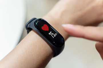 Close up image hand of male using smart watch with health app checking measure heart rate at normal levels - Powered by Adobe
